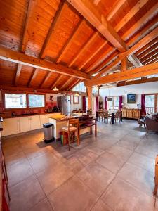 a large kitchen and dining room with wooden ceilings at Chalet La Savoyarde in Peisey-Nancroix