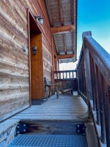 a wooden porch of a cabin with a wooden door at Chalet La Savoyarde in Peisey-Nancroix