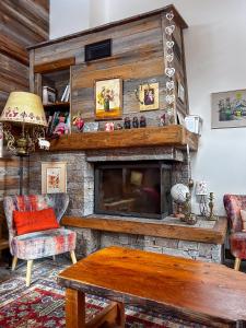 a living room with a fireplace and a table at Chalet La Savoyarde in Peisey-Nancroix