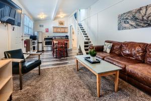 a living room with a leather couch and a table at A-Lodge Boulder in Boulder