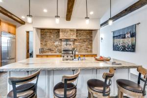 a kitchen with a large island with bar stools at Epic East Wenatchee Home with Hot Tub and Game Room! in East Wenatchee