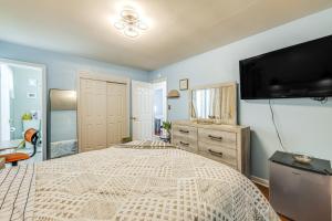 a bedroom with a large bed and a flat screen tv at Colonial Heights Home with Large Yard and BBQ Grill! in Colonial Heights