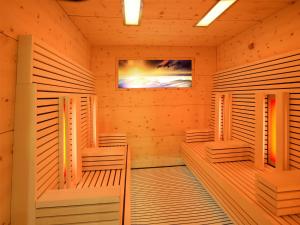 a sauna with wooden panels and a tv at Hotel Foestlerhof in Villa Ottone