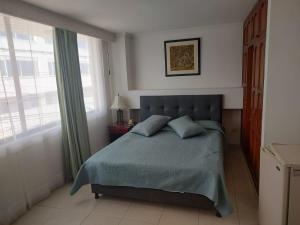 Postel nebo postele na pokoji v ubytování HOTEL COSTA DEL SOL FUSAGASUGa