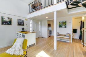 ein Wohnzimmer mit einem gelben Stuhl und einer Treppe in der Unterkunft Dreamy Hudson Valley Cottage with State Park Views in Garrison