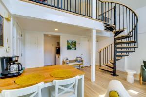 a dining room and living room with a spiral staircase at Dreamy Hudson Valley Cottage with State Park Views in Garrison