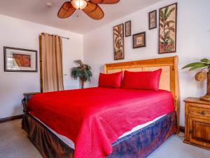 a bedroom with a red bed and a ceiling fan at Pool Side with free WiFi and Golf Pass in San Felipe +22 photos