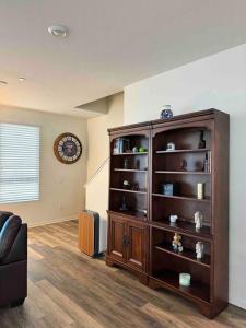 a large wooden book shelf in a living room at Vacation or Business trip in Downey