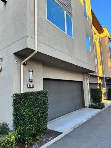 a apartment building with a garage door in front of it at Vacation or Business trip in Downey