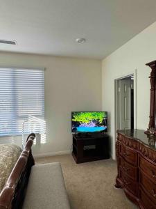 a living room with a flat screen tv in a room at 3 Bedroom Townhome with Large Living Area in Downey