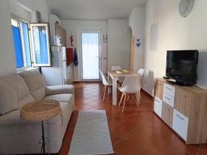 un soggiorno con divano e tavolo di Appartamento Sole a Cala Gonone