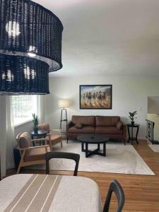 a living room with a couch and a table at 2023 Remodeled 4bed/2bath Home! in Gansevoort