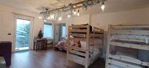 a room with three bunk beds and a desk at Casa Vacanza L'infinito per escursionisti - gruppi e famiglie in Pessinetto