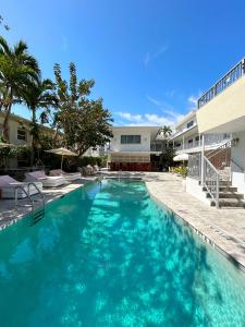 a swimming pool with blue water in front of a building at Royal Palms Resort & Spa in Fort Lauderdale