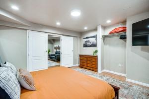 a bedroom with a bed and a flat screen tv at Pet-Friendly Utah Apartment 2 Mi to Amphitheatre in West Valley City