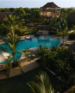 een uitzicht over een zwembad in een resort bij Zen Boutique Resort in Jambiani