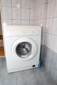 a washing machine in a room with a tile floor at Mary's Villas in Plomari