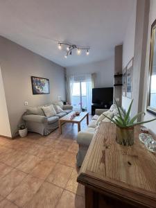 a living room with a couch and a table at Breathtaking Sunsets Flat in Las Palmas de Gran Canaria