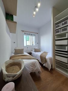 a bedroom with two beds and a tub in it at Breathtaking Sunsets Flat in Las Palmas de Gran Canaria