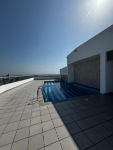 a swimming pool on the roof of a building at Apartaestudio Luxur en Barranquilla in Barranquilla