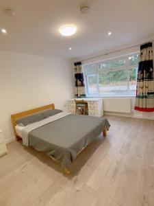 a bedroom with a bed and a window at Cloud Green apartment in Canley