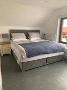 ein Schlafzimmer mit einem großen Bett mit einer blauen Decke in der Unterkunft Red Sheds Villa Portarlington 