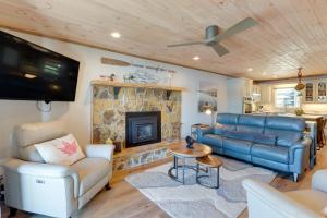 a living room with a couch and a fireplace at Lakefront Townhome with Dock 6 Mi to Blue Ridge! in Morganton