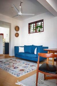 a living room with a blue couch and a table at Stay with Adhiambo in Kilifi