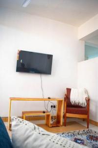 a living room with a tv hanging on the wall at Stay with Adhiambo in Kilifi