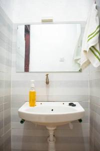 a white sink in a bathroom with a mirror at Stay with Adhiambo in Kilifi