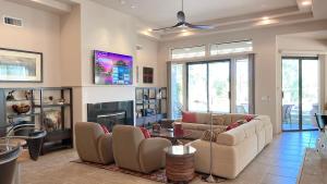 a living room with two couches and a fireplace at DOUBLE EAGLE: Your private desert resort awaits. Pool, Views, Guesthouse! Managed by Greenday. in Rancho Mirage