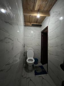 a small bathroom with a toilet in a stone wall at TAMRI BEACH HOUSE in Tamri