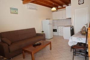 a living room with a couch and a table at Mary's Villas in Plomari