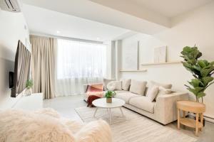 a living room with a couch and a table at Loft Deluxe & Fun - Downtown Quebec in Quebec City