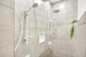 a shower with two shower heads in a bathroom at Loft Deluxe & Fun - Downtown Quebec in Quebec City +11 photos