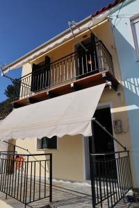 a white awning on the side of a building at Mary's Villas in Plomari