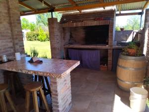 a patio with a table and a wine barrel at Descanso Cordillerano in San Rafael