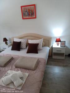 a bedroom with a large bed with two pillows at Happy Star in Niš