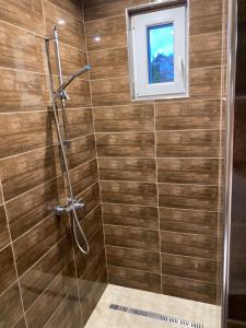 a bathroom with a shower with a window at Pompa Villa in Galyatető +25 photos