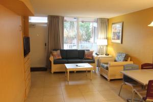 a living room with a couch and a table at Canada House Beach Club Resort in Pompano Beach