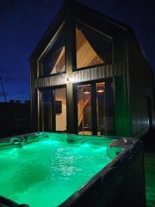 a swimming pool in front of a house at night at Loft Point 1 