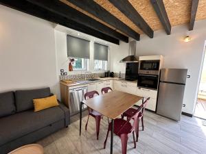 a kitchen and living room with a table and a couch at Alaimo et Les2Roses in Paray-le-Monial