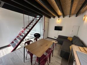 a living room with a table and a couch at Alaimo et Les2Roses in Paray-le-Monial