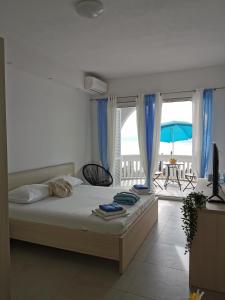 a bedroom with a bed with a view of the ocean at Villa Bellevue in Novi Vinodolski