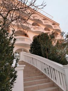 una escalera que conduce a un edificio rosa en Villa Bellevue en Novi Vinodolski