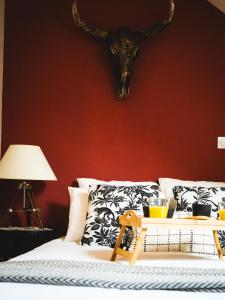a bedroom with a bed with a skull on the wall at L'Insolite, Suite safari d'exception à Saumur in Saumur