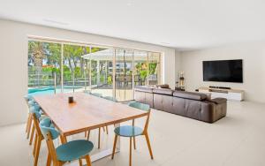 a living room with a table and chairs and a couch at Mermaid Waters House in Gold Coast