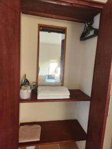 a small room with a mirror and a shelf at Adhiambo's Studio near Bofa Beach in Kilifi