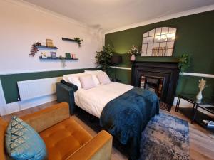 uma sala de estar com uma cama e uma lareira em HIL Stays - Baxter Park View em Dundee