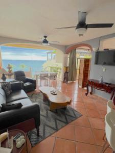 a living room with a view of the ocean at Marboka Hotel & Suites in Puerto Vallarta